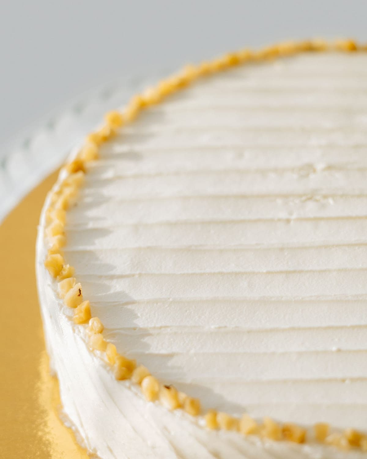 Close-up of textured ivory buttercream finished with a piped pearl border